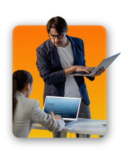 Two colleagues looking at a laptop